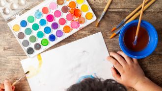 Child painting with watercolors.