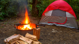 Campsite with tent and fire.